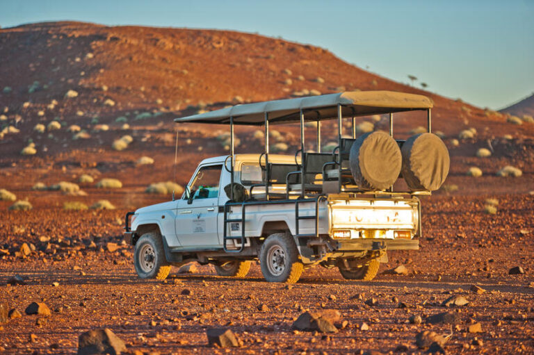 A vehicle standing in the rocky desert at the Palmwag Lodge.
